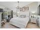 Comfortable bedroom featuring white furnishings, a chandelier, and natural light from the windows at 7118 Lakeside Dr # 7118, Sarasota, FL 34243