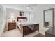 Comfortable bedroom with light wood floors, ceiling fan and a large decorative mirror at 7118 Lakeside Dr # 7118, Sarasota, FL 34243