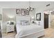 Bedroom showcasing a white bed, decorative chandelier, and a modern barn door to the bathroom at 7118 Lakeside Dr # 7118, Sarasota, FL 34243