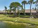 Scenic lake view from the rear of the villas with beautiful lawn and landscaping at 7118 Lakeside Dr # 7118, Sarasota, FL 34243