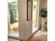 Inviting foyer with a serene courtyard view, elegant decor, and natural light at 7118 Lakeside Dr # 7118, Sarasota, FL 34243
