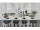 Beautifully remodeled kitchen featuring white cabinets, stainless steel appliances, and a breakfast bar at 7118 Lakeside Dr # 7118, Sarasota, FL 34243