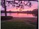 Scenic lake view showcasing a vibrant pink and purple sunset reflecting off the water at 7118 Lakeside Dr # 7118, Sarasota, FL 34243