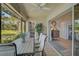 Screened-in lanai with table and chairs, open to the living area via sliding glass doors at 7118 Lakeside Dr # 7118, Sarasota, FL 34243