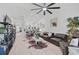 Spacious living room with leather sectional, modern ceiling fan, and an open layout to the kitchen at 7118 Lakeside Dr # 7118, Sarasota, FL 34243