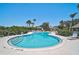 Beautiful community pool with seating and tropical landscaping providing a relaxing atmosphere at 7118 Lakeside Dr # 7118, Sarasota, FL 34243