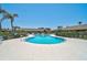 Community pool featuring a unique design, seating, and surrounding tropical landscaping at 7118 Lakeside Dr # 7118, Sarasota, FL 34243
