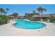 Well-maintained community pool area with lounge chairs and tropical landscaping at 7118 Lakeside Dr # 7118, Sarasota, FL 34243