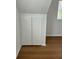 Attic with cabinet, window, and wood floors at 8412 Grove Blvd, Punta Gorda, FL 33982