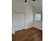 Cozy bedroom with a closet, hardwood floors, and a large window, offering ample natural light at 8412 Grove Blvd, Punta Gorda, FL 33982