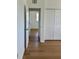 Bright bedroom featuring hardwood floors, white trim, and multiple closets for ample storage space at 8412 Grove Blvd, Punta Gorda, FL 33982