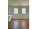 Upstairs bonus room with wood-look flooring and two windows with blinds at 8412 Grove Blvd, Punta Gorda, FL 33982