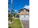 Side view of a well-maintained two-story home with a two-car garage, shed, and a meticulously kept lawn at 8412 Grove Blvd, Punta Gorda, FL 33982