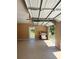 Spacious two-car garage interior, featuring an open garage door, clean epoxy floor, and a convenient backyard access at 8412 Grove Blvd, Punta Gorda, FL 33982