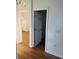 Hallway with views into other rooms with light-colored floors and white trim and doors at 8412 Grove Blvd, Punta Gorda, FL 33982