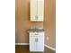 Laundry area features white cabinets above and below a countertop, with electrical outlets nearby at 8412 Grove Blvd, Punta Gorda, FL 33982