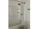 Bright white shower and tub combination with a chrome shower head at 8412 Grove Blvd, Punta Gorda, FL 33982