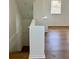 View of the stairs from the upstairs bonus room, features wood-look flooring at 8412 Grove Blvd, Punta Gorda, FL 33982