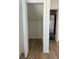 Open storage closet next to HVAC unit with wood-look flooring and white painted walls at 8412 Grove Blvd, Punta Gorda, FL 33982