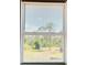 A bright window with blinds showing a view of lush green trees and foliage outside at 8412 Grove Blvd, Punta Gorda, FL 33982