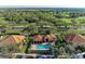 Aerial view of residential community and clubhouse, with lush landscaping and green spaces at 8422 Wethersfield Run # 103, Lakewood Ranch, FL 34202