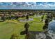 Aerial view of golf course community featuring lush greenery, ponds, and well-maintained homes at 8422 Wethersfield Run # 103, Lakewood Ranch, FL 34202