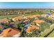 Aerial view of community featuring lush landscaping, green spaces, golf course, and community pool at 8422 Wethersfield Run # 103, Lakewood Ranch, FL 34202