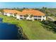 Aerial view of lakeside condos with well-manicured lawns at 8422 Wethersfield Run # 103, Lakewood Ranch, FL 34202