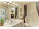 Bathroom with vanity, sink, framed mirror, and shower-tub combination at 8422 Wethersfield Run # 103, Lakewood Ranch, FL 34202