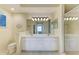 Bright bathroom with double sinks, modern fixtures, and a glass-enclosed shower, offering a spa-like experience at 8422 Wethersfield Run # 103, Lakewood Ranch, FL 34202