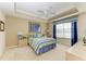 Comfortable bedroom with plush carpet, tray ceiling, ceiling fan and ample natural light at 8422 Wethersfield Run # 103, Lakewood Ranch, FL 34202
