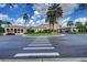 Exterior view of the elegant clubhouse, showcasing its beautiful architecture and meticulously maintained surroundings at 8422 Wethersfield Run # 103, Lakewood Ranch, FL 34202