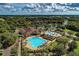 Aerial shot showcasing the community pool, clubhouse, and lush surroundings of this beautiful neighborhood at 8422 Wethersfield Run # 103, Lakewood Ranch, FL 34202