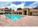 Community pool is surrounded by a brick deck and has a covered structure with lounge chairs at 8422 Wethersfield Run # 103, Lakewood Ranch, FL 34202