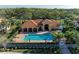 Aerial view of community pool, clubhouse, with lounge chairs, and a covered seating area at 8422 Wethersfield Run # 103, Lakewood Ranch, FL 34202