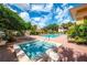 Community pool and hot tub with surrounding lounge chairs and lush landscaping for relaxing outdoor living at 8422 Wethersfield Run # 103, Lakewood Ranch, FL 34202