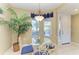 Cozy dining area featuring a glass table, decorative chairs, and natural light, enhancing the home's charm at 8422 Wethersfield Run # 103, Lakewood Ranch, FL 34202