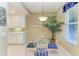 Inviting dining area with a glass table, comfortable seating, and ample natural light, perfect for gatherings at 8422 Wethersfield Run # 103, Lakewood Ranch, FL 34202