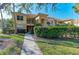 Inviting two-story condo exterior with manicured landscaping and a charming walkway at 8422 Wethersfield Run # 103, Lakewood Ranch, FL 34202
