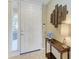 Bright foyer featuring a white door, tile flooring, and decorative wall art at 8422 Wethersfield Run # 103, Lakewood Ranch, FL 34202