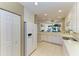 Spacious kitchen featuring white appliances, cabinetry, and a tile floor, offering a seamless blend of style at 8422 Wethersfield Run # 103, Lakewood Ranch, FL 34202