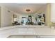 Bright kitchen with a view of the living area, featuring pristine countertops and white cabinetry at 8422 Wethersfield Run # 103, Lakewood Ranch, FL 34202