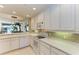 Open kitchen design with sleek appliances, tile backsplash, and seamless flow to the living area at 8422 Wethersfield Run # 103, Lakewood Ranch, FL 34202