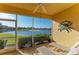 Relaxing screened lanai with lake view and patio furniture at 8422 Wethersfield Run # 103, Lakewood Ranch, FL 34202