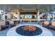 Community outdoor seating with a fire pit, overhead lighting, and elegant architectural design at 8422 Wethersfield Run # 103, Lakewood Ranch, FL 34202