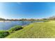 Lakeside community featuring pond with manicured green space at 8422 Wethersfield Run # 103, Lakewood Ranch, FL 34202