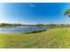 Scenic view of pond surrounded by lush grass and residences at 8422 Wethersfield Run # 103, Lakewood Ranch, FL 34202