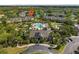 Aerial view of community featuring a pool, clubhouse, palm trees and tranquil lake at 8926 Manor Loop # 201, Lakewood Ranch, FL 34202