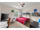 Bright bedroom with a bunk bed, ceiling fan, and playful decor at 8926 Manor Loop # 201, Lakewood Ranch, FL 34202