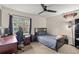 Comfortable bedroom with a ceiling fan, ample natural light, and a dedicated workspace at 8926 Manor Loop # 201, Lakewood Ranch, FL 34202